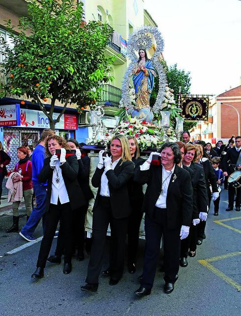 Women carry Our Lady of the Immaculate Conception in Arroyo de la Miel. 
