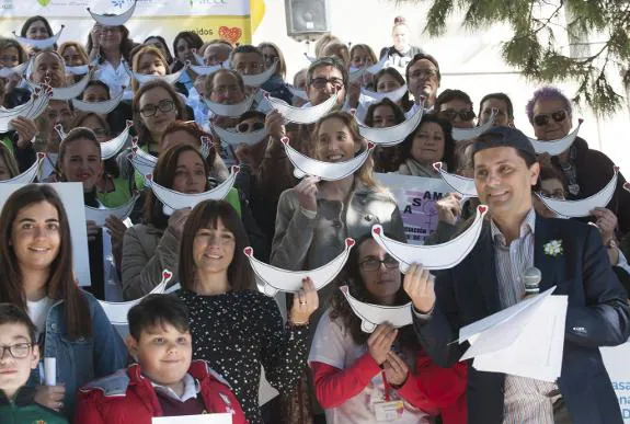 Those who took part in the demonstration held up cardboard smiles as symbols of hope and optimism.