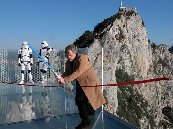 Mark Hamill 'cuts' the ribbon with a lightsaber.