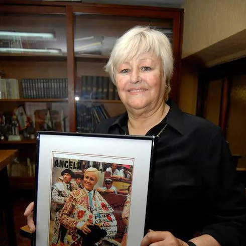 Angela, in 2011, with a photo from her bullfighting days.