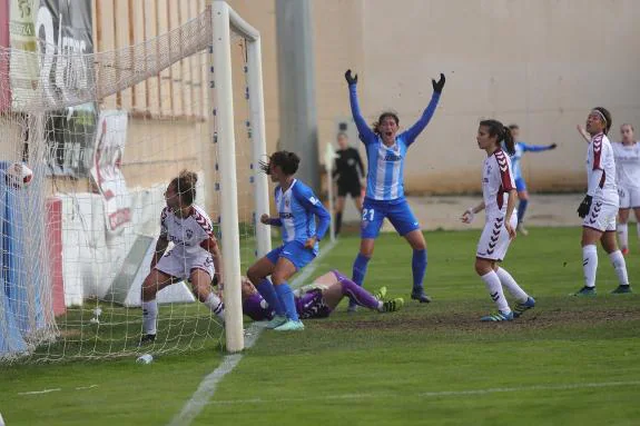 The Malaga players celebrate Leti's equaliser.