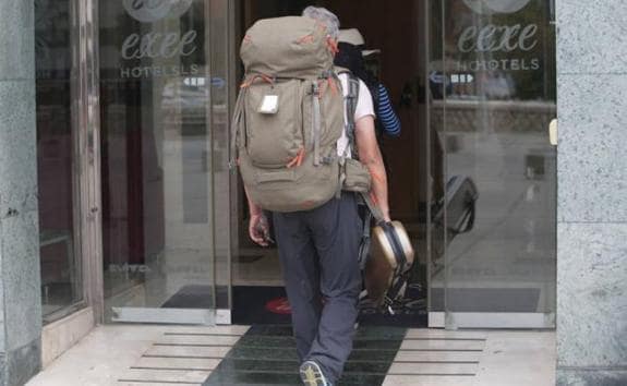 A tourist enters a hotel in Malaga.