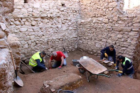 Archaeologists work on the site. 