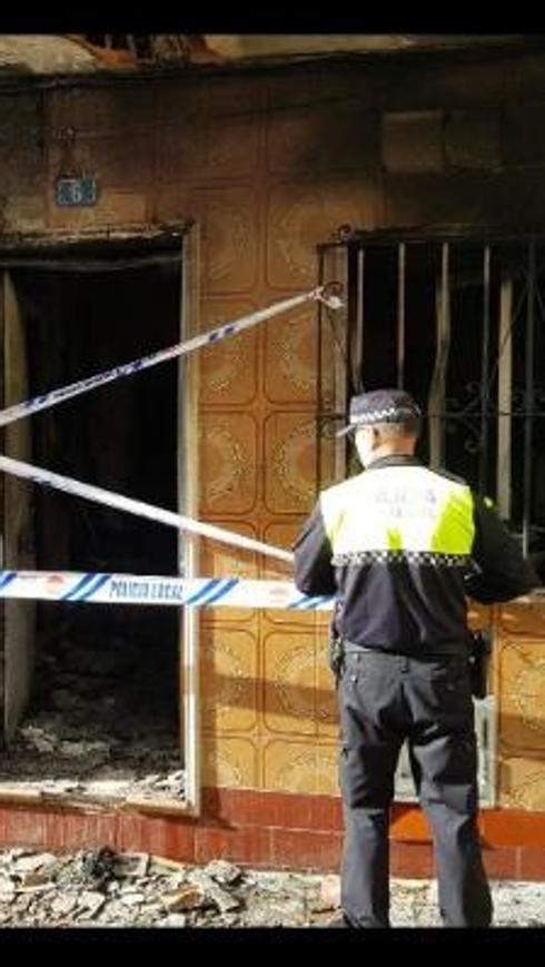 The burned-out home. 