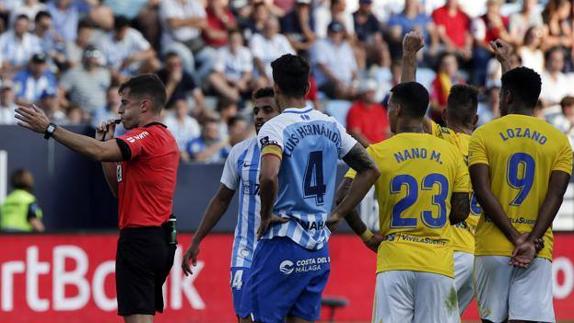 The referee awards Cadiz a goal against Malaga after a VAR check.