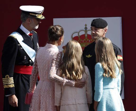 The royal family talk to the parachutist after the incident.