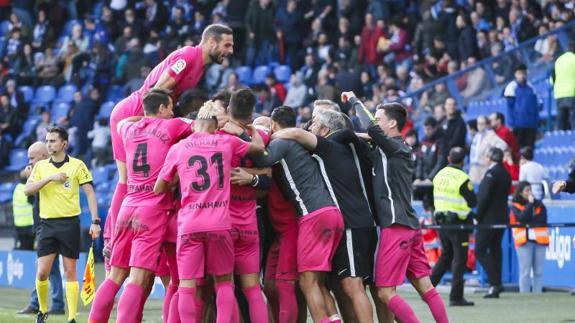 Malaga’s players celebrate Sadiku’s late goal which sealed three points against Deportivo.