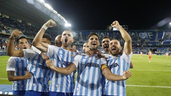 Malaga's players celebrate their second.