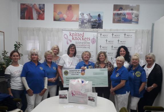 La Cala Lions hand over their cheque to Knitted Knockers and the AECC.