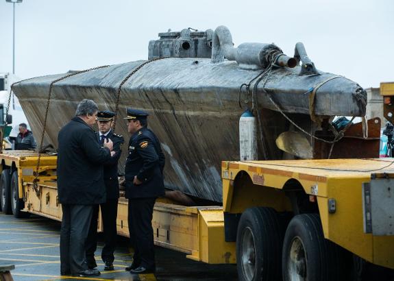 Officials next to the fibreglass submarine in Galicia on Wednesday. 