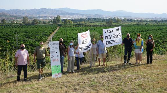 Protesters on the land where the plant is set to be built.