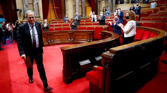Exiting stage right: Torra leaves the Catalan parliament after being invited as a guest for a last speech.