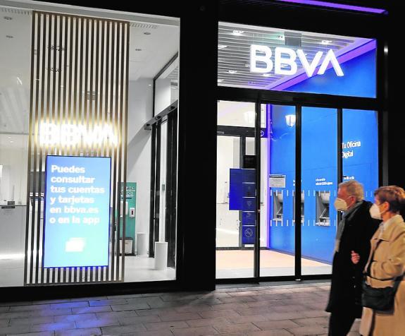 A couple pass a BBVA branch in the firm's home city of Bilbao. 