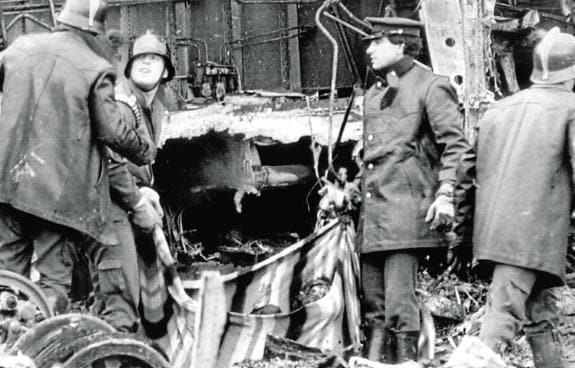 Firefighters with some of the wrecked fuselage at the scene.