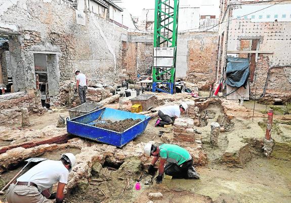 Ten archaeologists are working on the site. The structure of the church can be seen at the back.