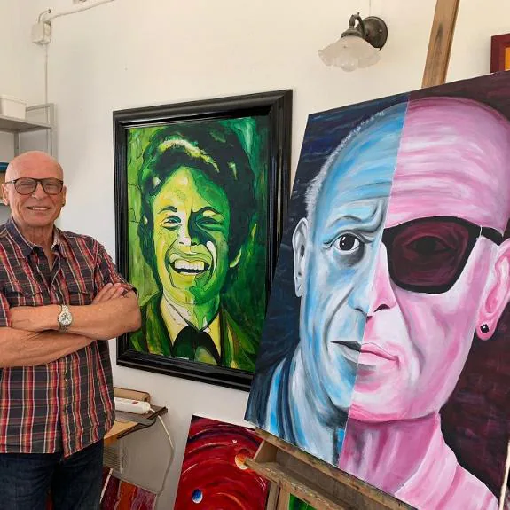Udo Burkhardt in his studio with two of his paintings, including the Picasso and Me portrait. 