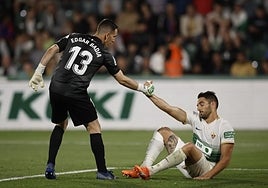 Edgar Badía ayuda a levantarse al central Pedro Bigas en el partido ante el Barcelona