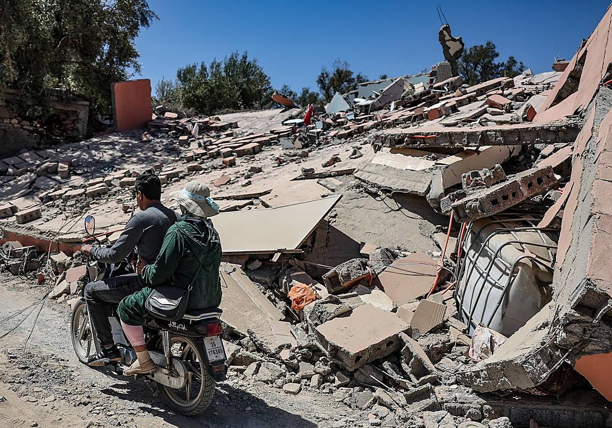 Ciudadanos de una aldea cercana a Marrakech pasa frente a una casa