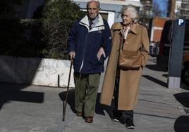 Una pareja de pensionistas, caminando por la calle.
