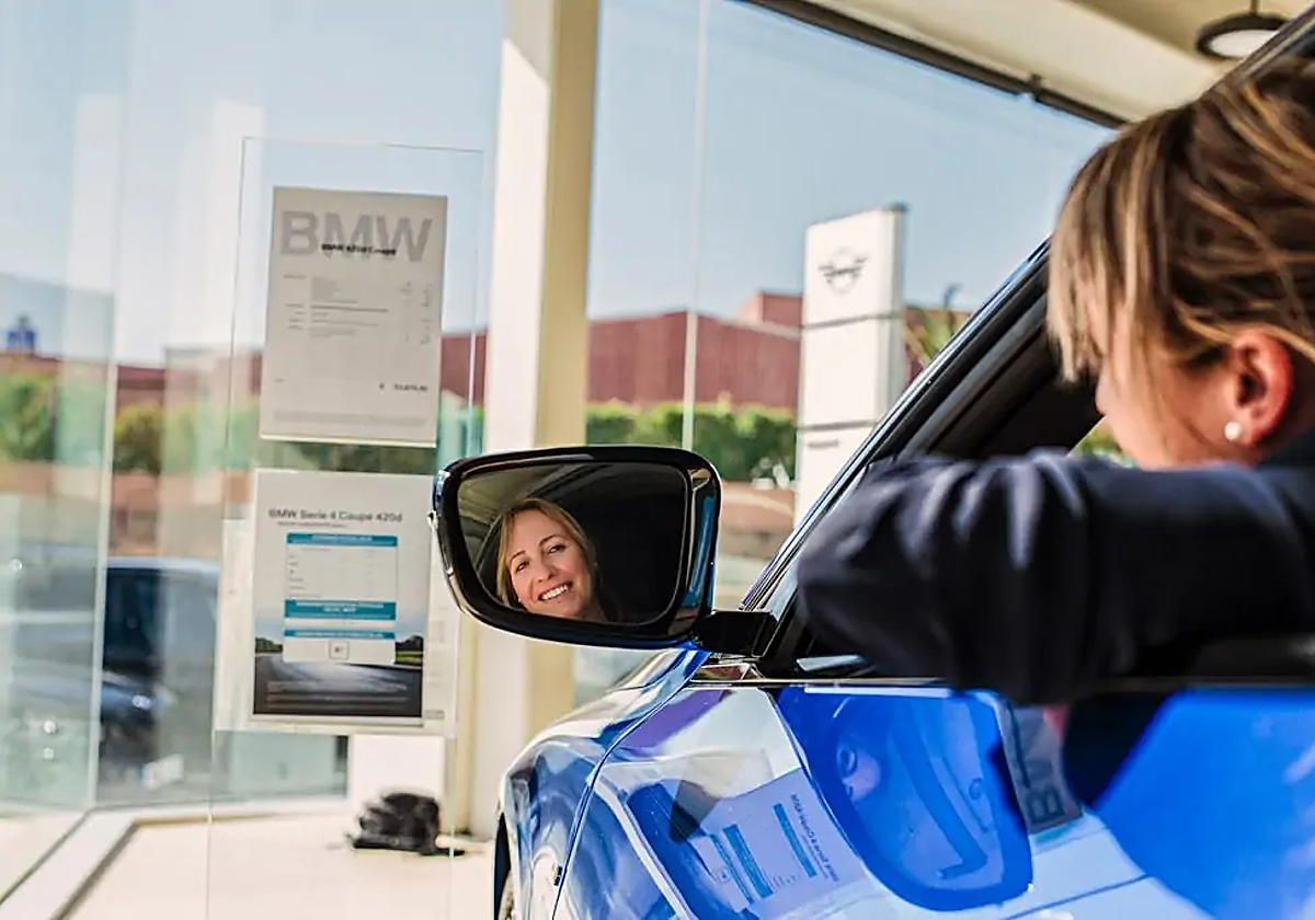 Imagen de una mujer subida a uno de los vehículos disponibles en Benigar.