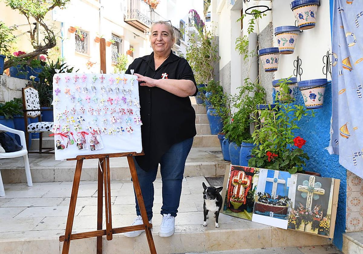 Imagen principal - María José Tarancón y su perrita Carmen junto a las Cruces de Mayo que elabora en forma de broche.