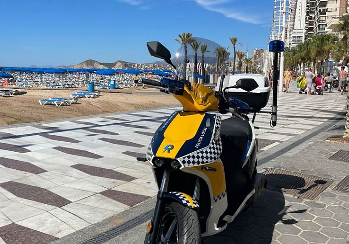 Imagen de una moto de la Policía Local de Benidorm en la playa de Levante