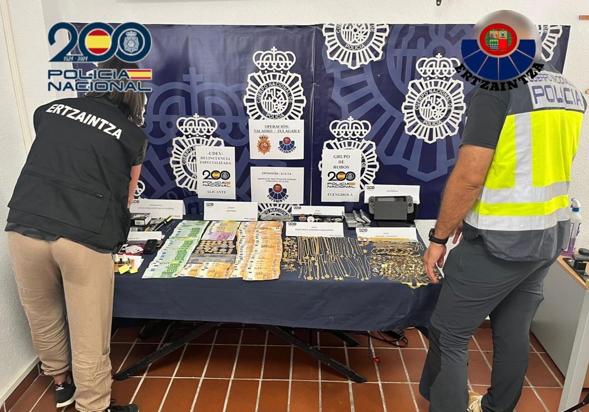 Agentes de la Policía Nacional y la Ertzaintza junto al material incautado.