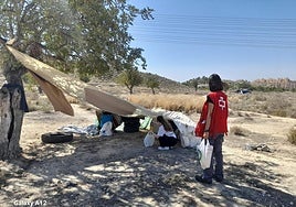 Voluntarias de Cruz Roja ofrecen líquidos a una persona sin hogar.