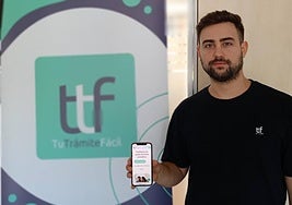 Fran Mas, uno de los creadores de la startup, posa con la plataforma y el logo al fondo.