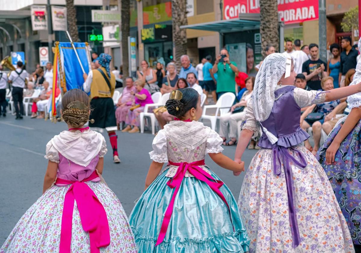 Several girls in 18th-century attire during a 2024 parade.