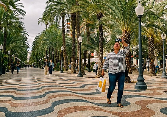 Turista haciendo una foto en la Explanada de Alicante.