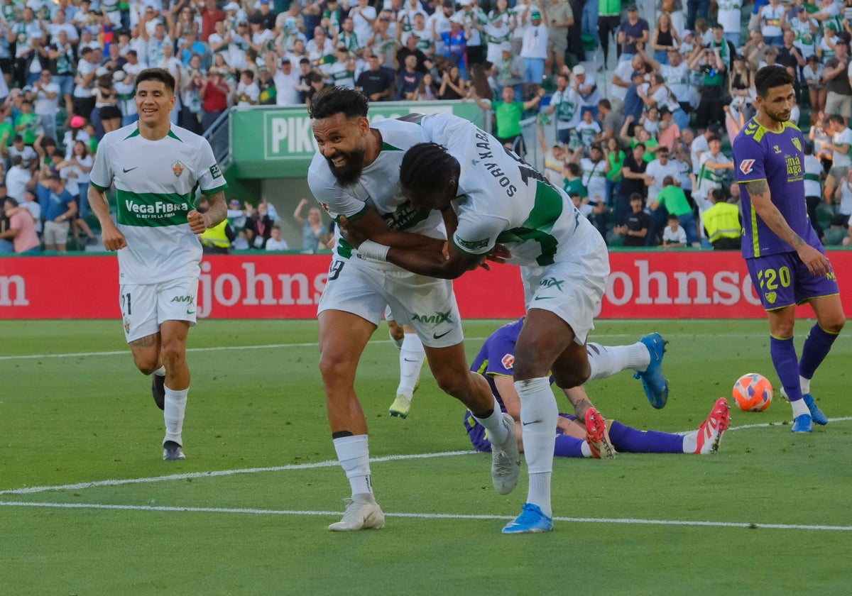 Sory Kaba and Mourad embrace after the first goal of the match.