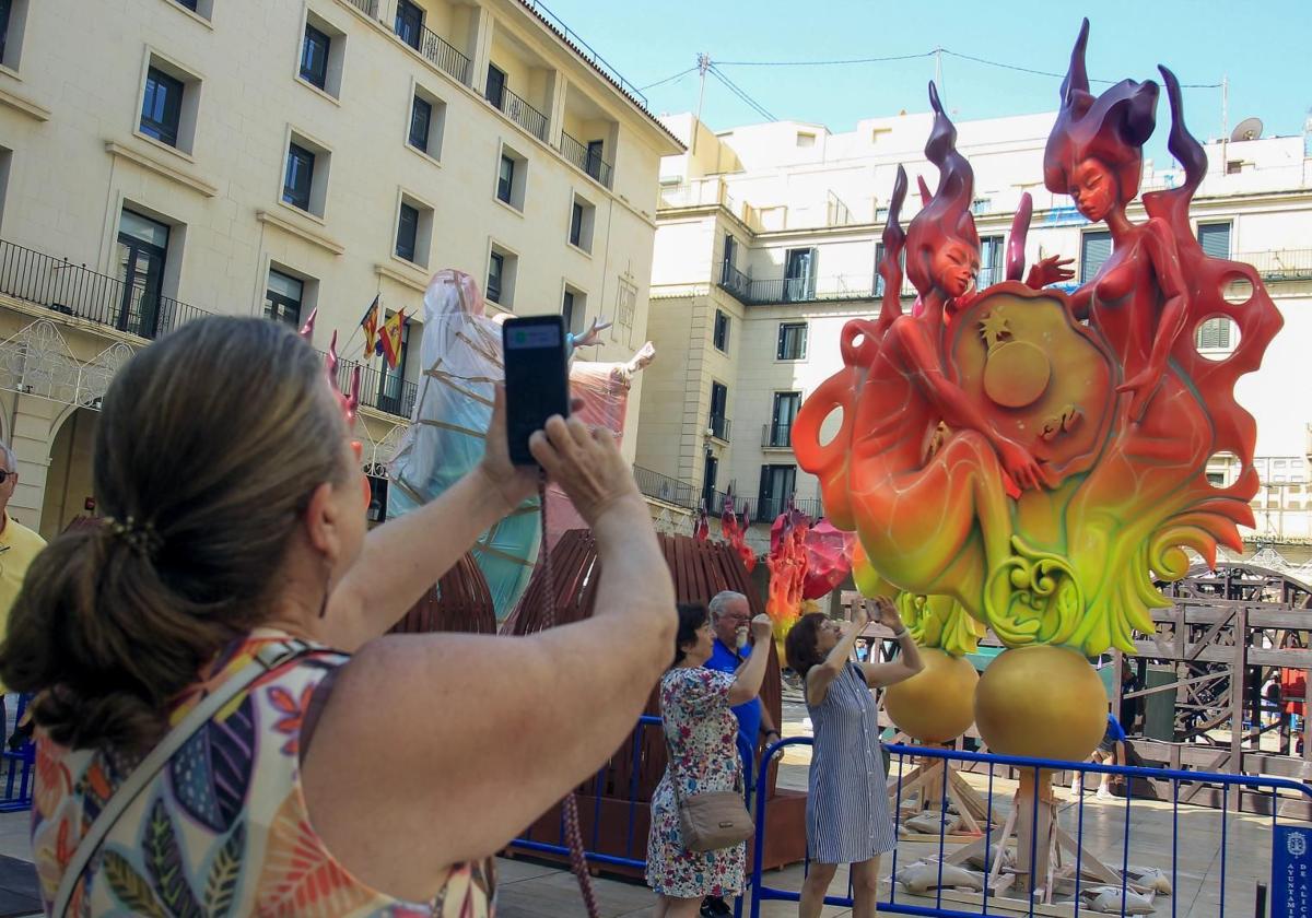 A tourist takes a photo of the Official Bonfire of Alicante.