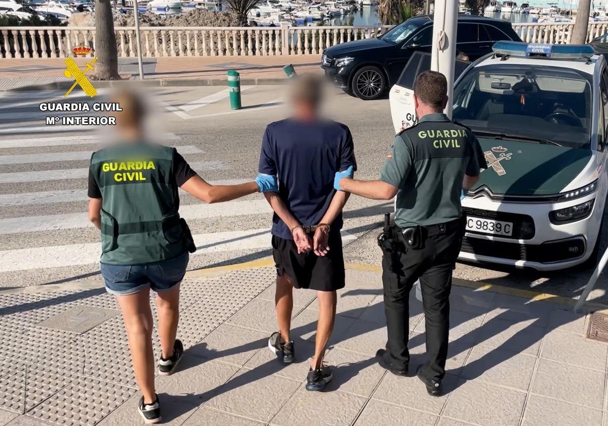 Civil Guard officers escort the detainee.