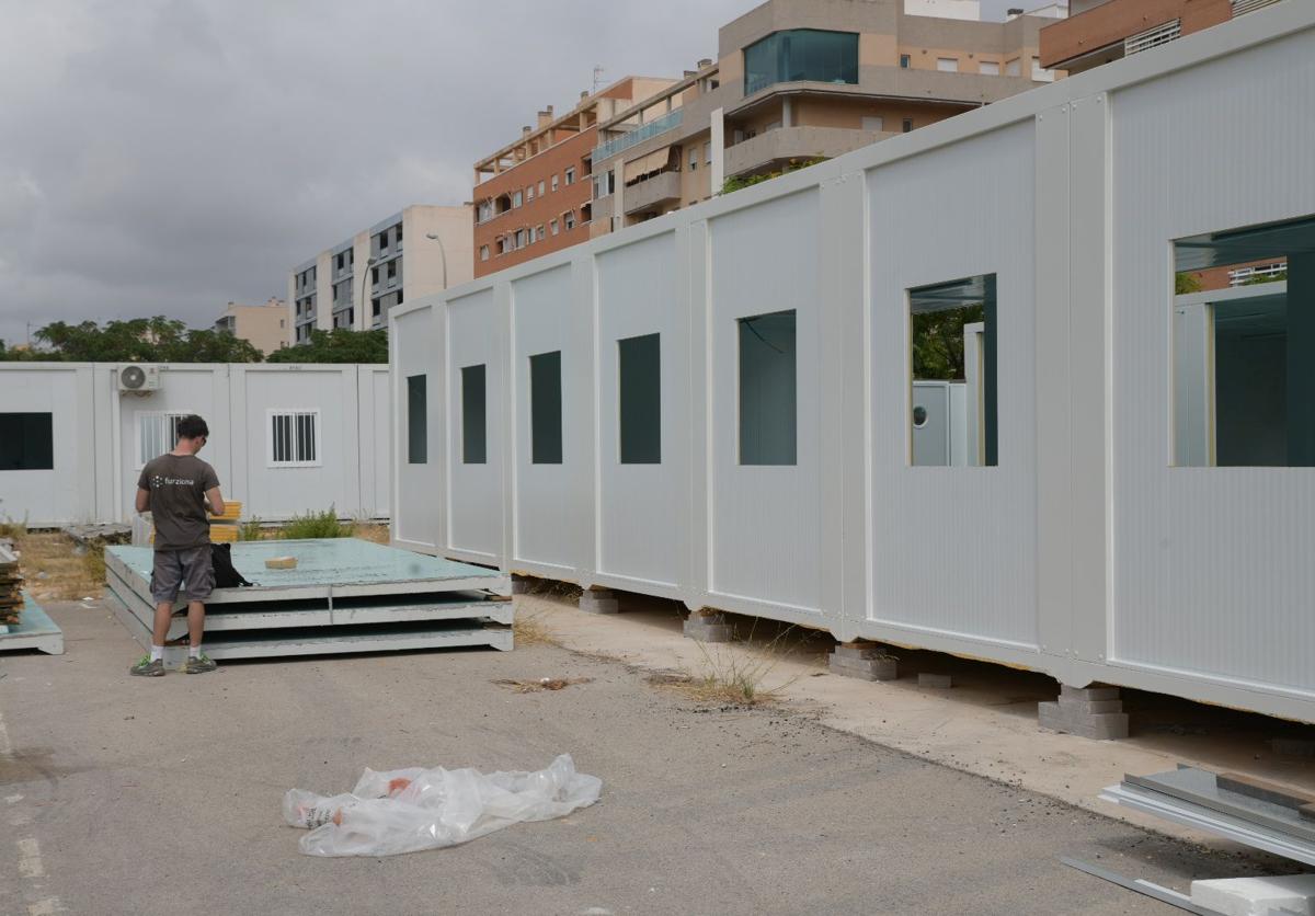 Installation work on temporary classrooms, just weeks before the start of classes.