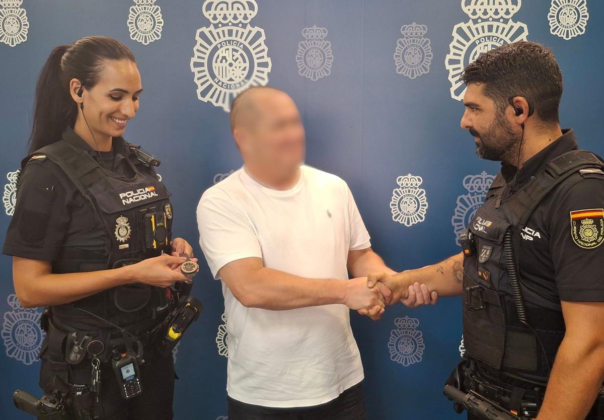 National Police officers return the recovered watch to its rightful owner.