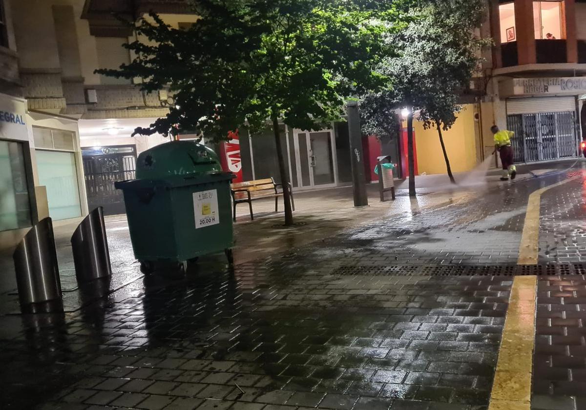 A worker cleaning the ground