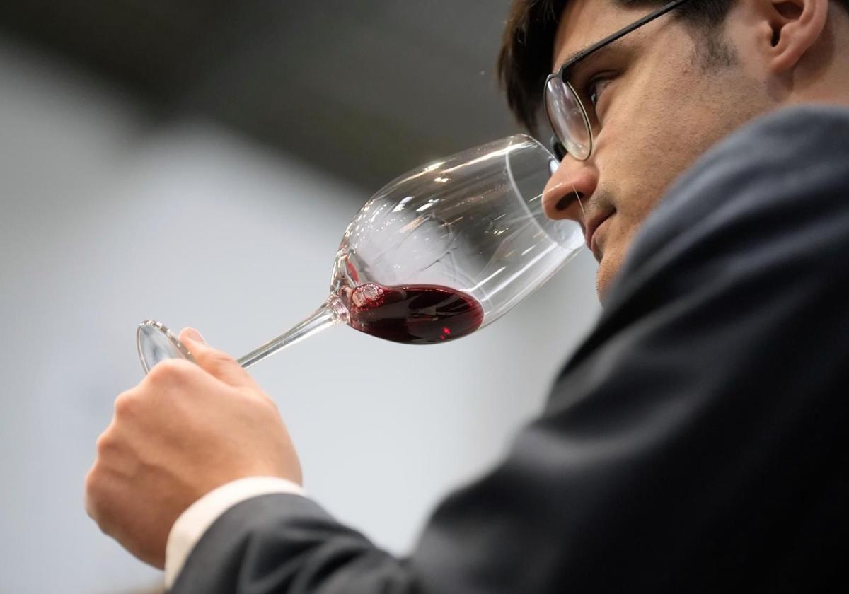 An expert tasting a glass of wine.