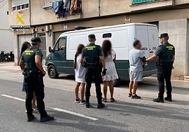 Guardias civiles custodian a los cuatro arrestados.