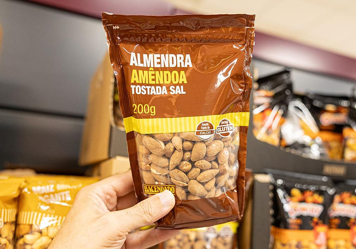 Salted roasted almonds on the shelves of Mercadona supermarket.