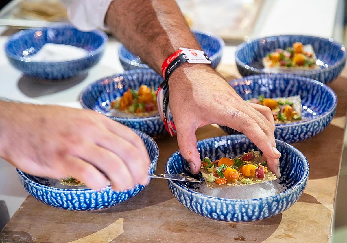 A chef prepares a tapa.