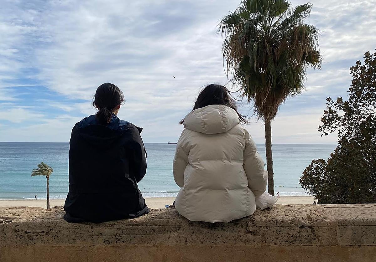 Two girls observe Postiguet Beach.